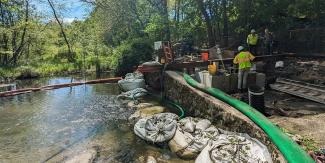 Construction work along a river for a treatment train in May 2024